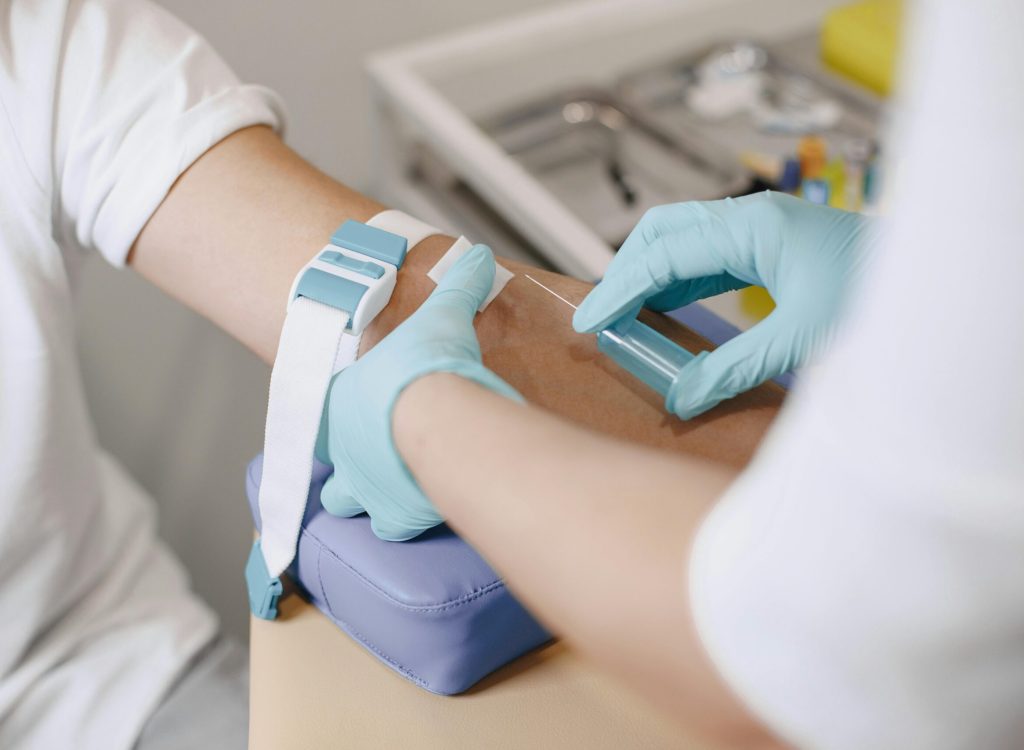 pexels-photo-6285344-6285344 Close-up of a healthcare professional drawing blood from a patient in a medical setting.